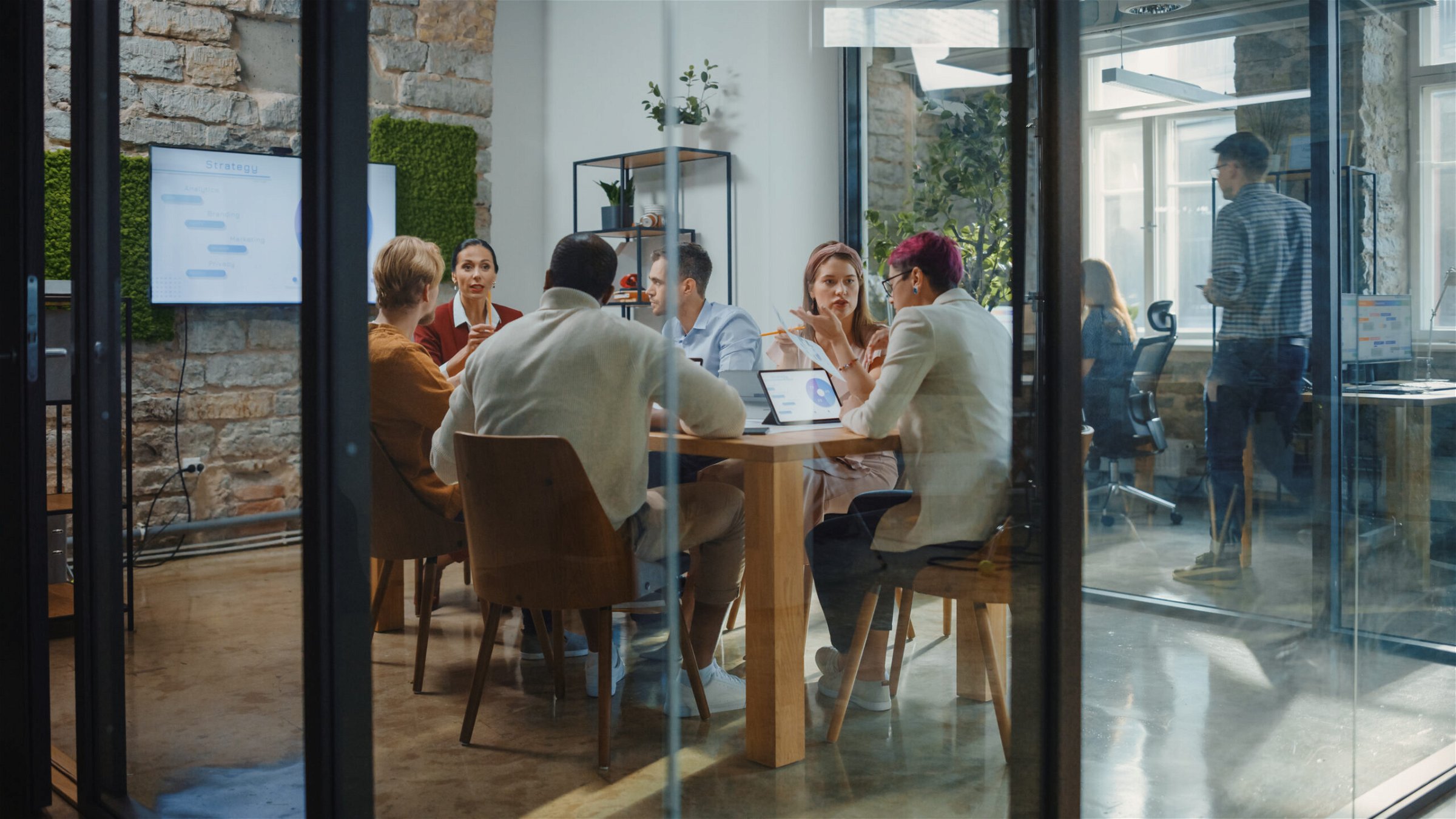 A team having an effective meeting in a glass room.