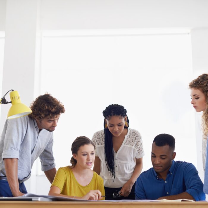 A team working together at their computer.